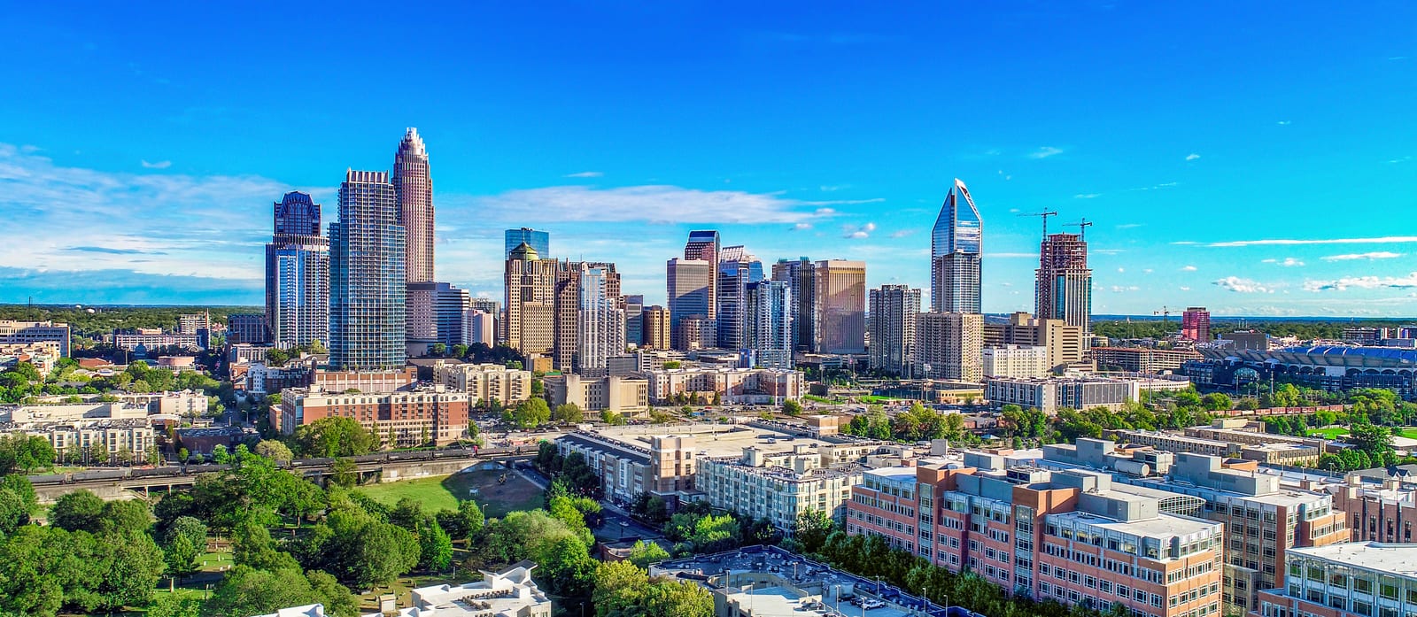 A modern city skyline at dusk under a clear blue sky